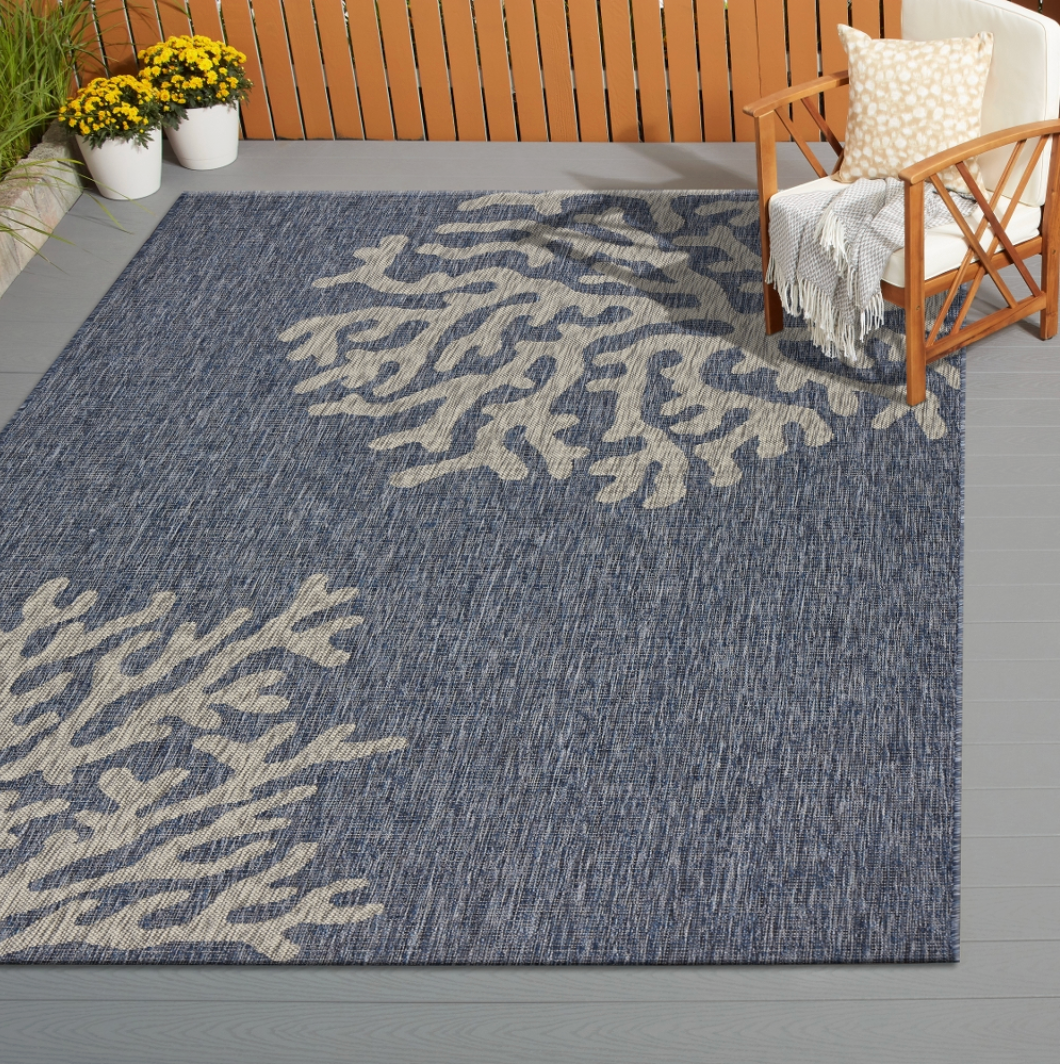 Blue outdoor rug with coral pattern.