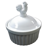 A white ceramic lidded dish with a fluted base and a rooster-shaped handle on top.