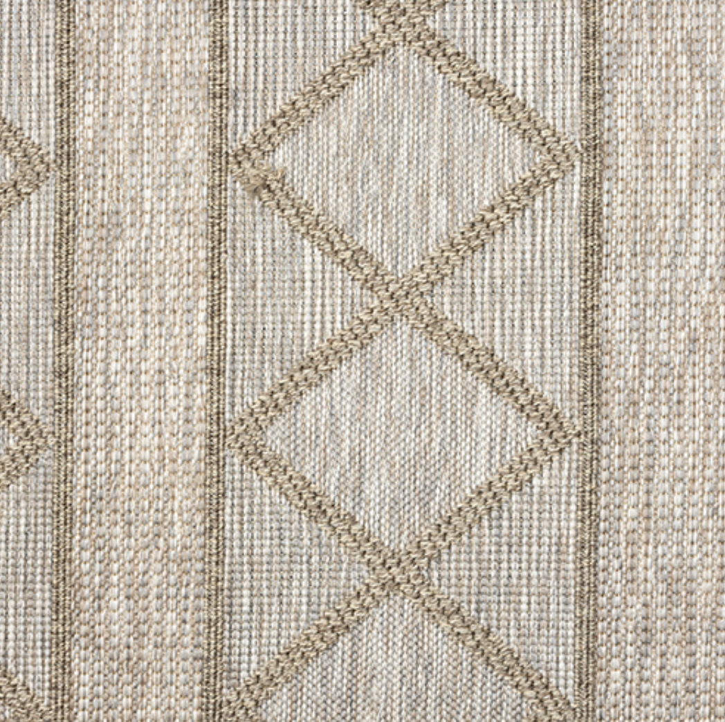 Close-up of a textured fabric with diamond pattern in neutral colors