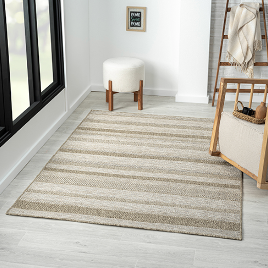 A rectangular area rug with horizontal beige and gray stripes.