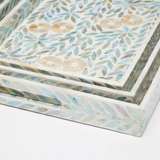 A close-up of a decorative rectangular tray with a mother-of-pearl inlay pattern featuring blue, beige, and white leaf and floral.