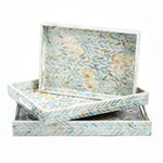 A set of three rectangular trays with a floral pattern and mother of pearl design, in shades of blue and white.