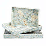 A set of three rectangular trays with a floral pattern and mother of pearl design, in shades of blue and white.