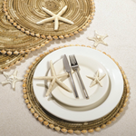 Table setting with starfish, shell placemats.