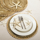 Table setting with starfish, shell placemats.