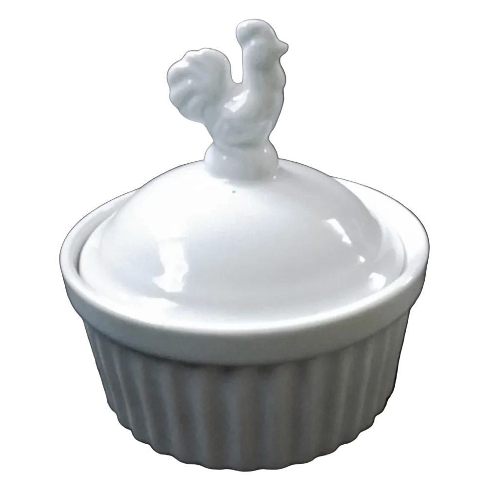A small white ceramic lidded container with a ribbed base and a rooster-shaped lid handle,.