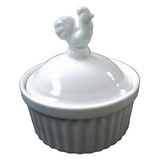 A small white ceramic lidded container with a ribbed base and a rooster-shaped lid handle,.