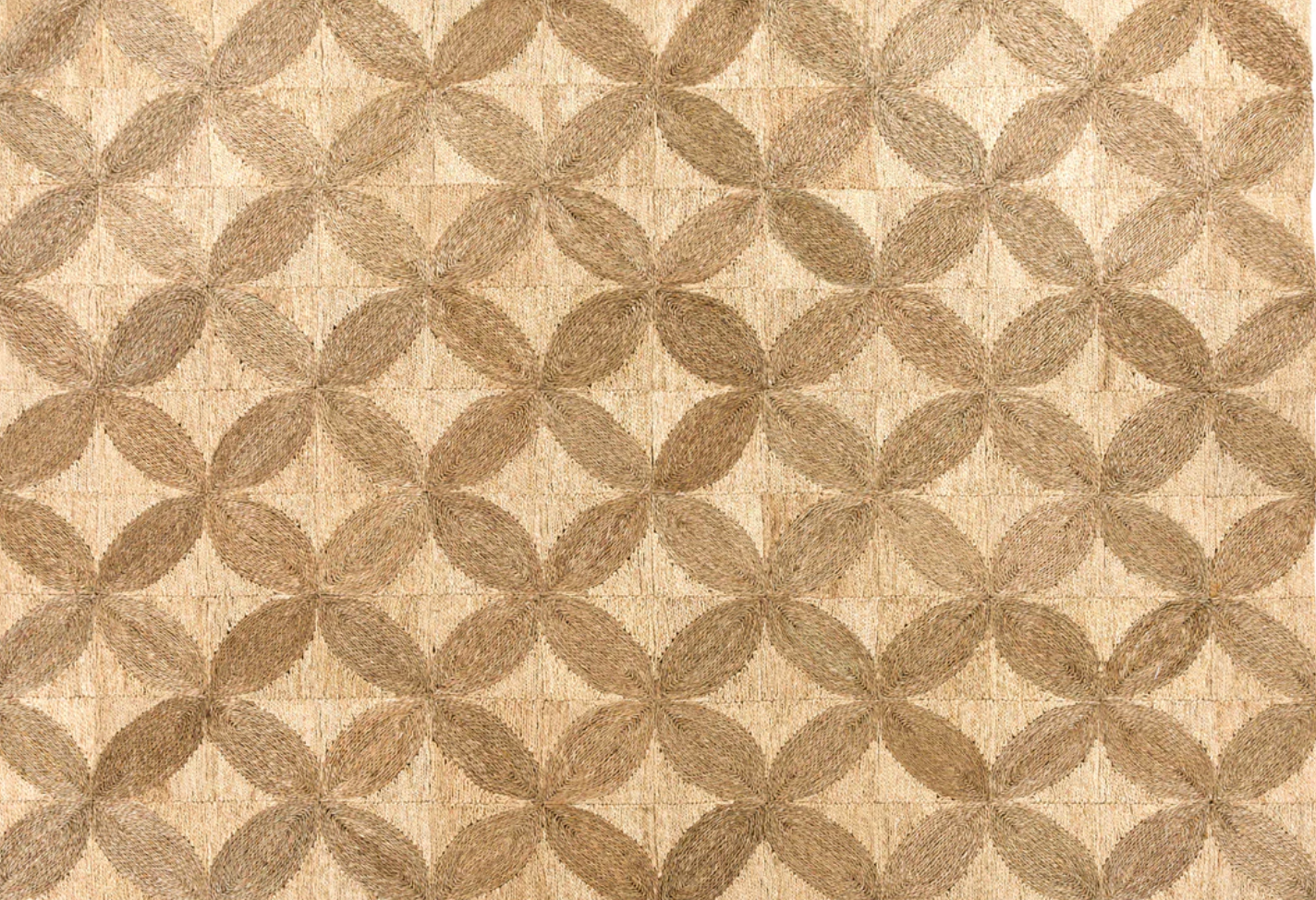 A close-up of a woven textile or rug pattern featuring interlocking oval shapes in warm beige and taupe-brown tones.