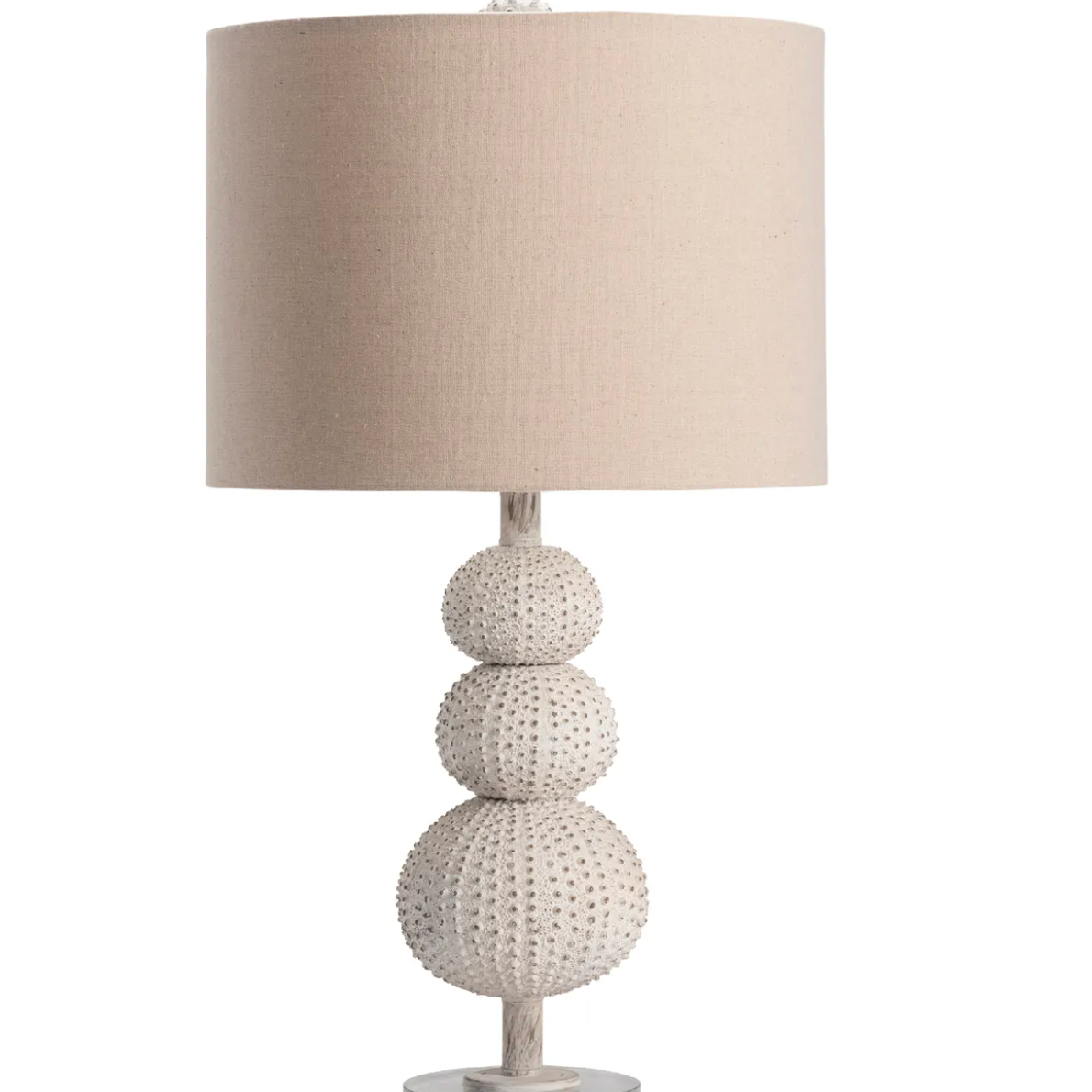 Table lamp with textured base and beige shade .