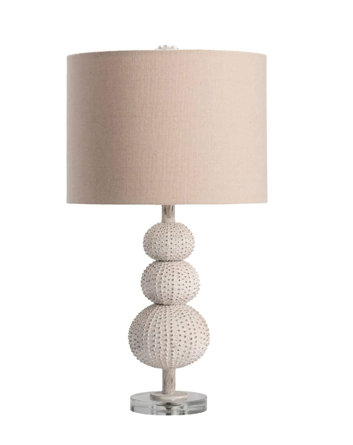 Table lamp with textured base and beige shade .