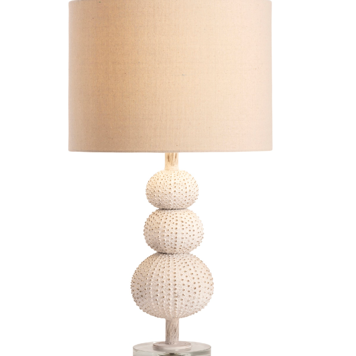 Table lamp with textured base and beige lampshade.