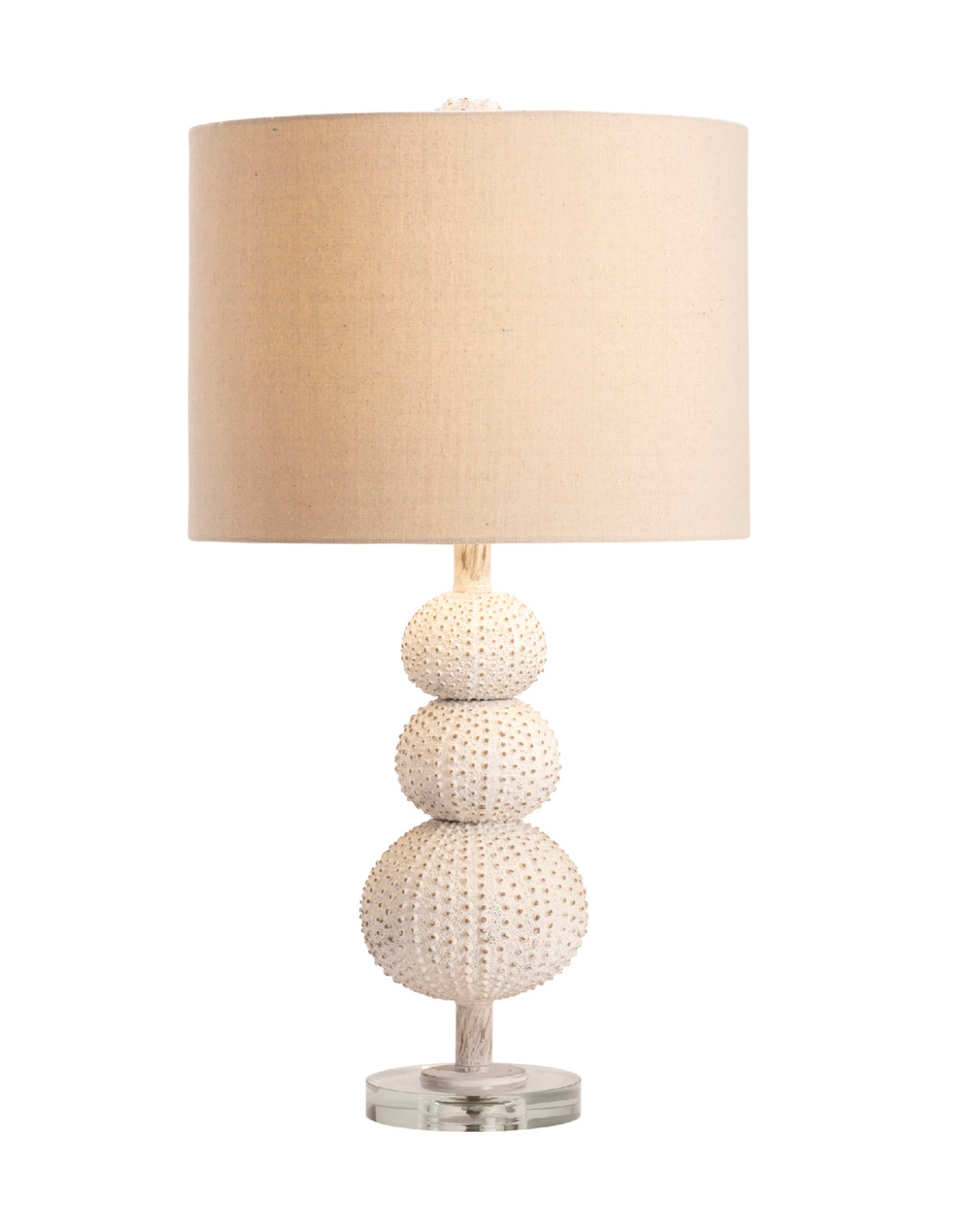 Table lamp with textured base and beige lampshade.