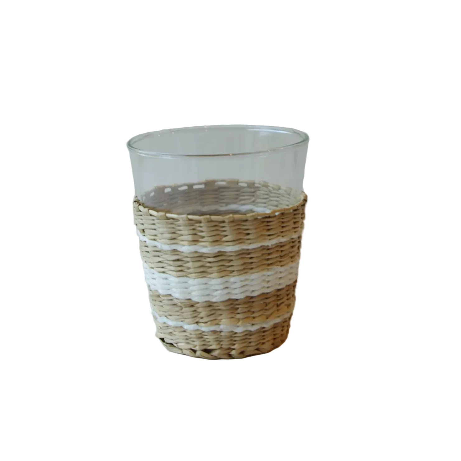 Clear glass tumbler with woven straw base .
