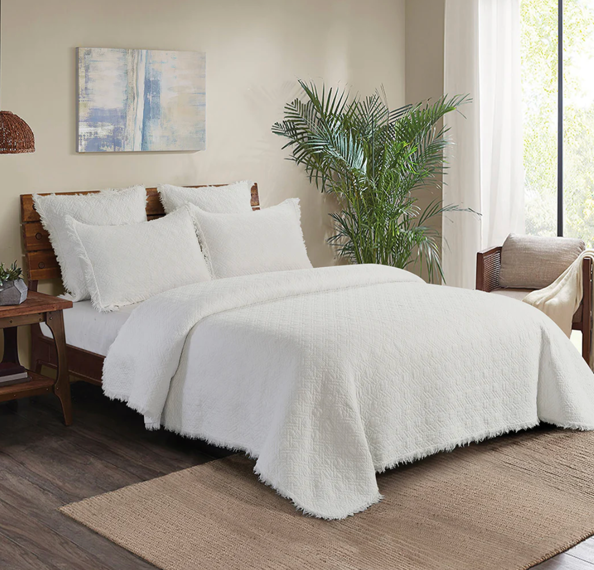White textured comforter on a bed.