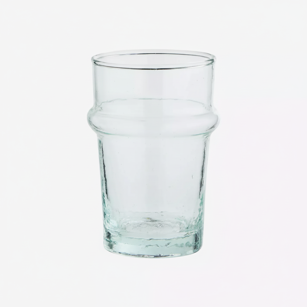 A clear glass tumbler with a thick base and a subtle flared shoulder.