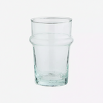A clear glass tumbler with a thick base and a subtle flared shoulder.