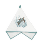 A white cotton kitchen towel with a sea turtle and coral design, featuring a light blue-green border and hanging loop.