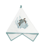 A white cotton kitchen towel with a sea turtle and coral design, featuring a light blue-green border and hanging loop.
