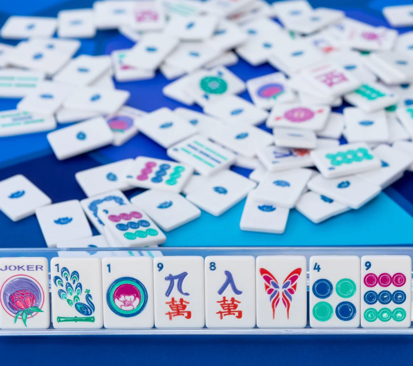 Collection of colorful麻将 tiles on a blue tray