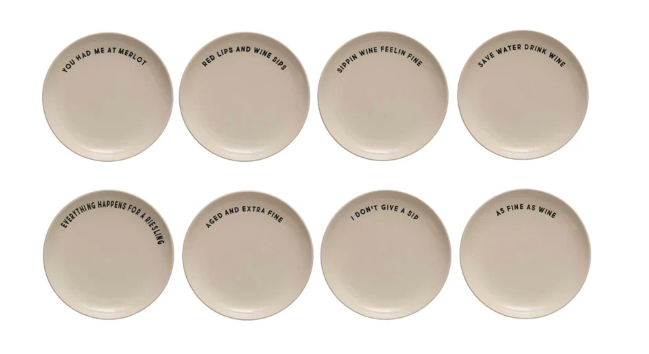 Eight round ceramic coasters in a warm off-white color, arranged in two rows of four on a plain white background. Each coaster features a different humorous phrase printed in black sans-serif font.
