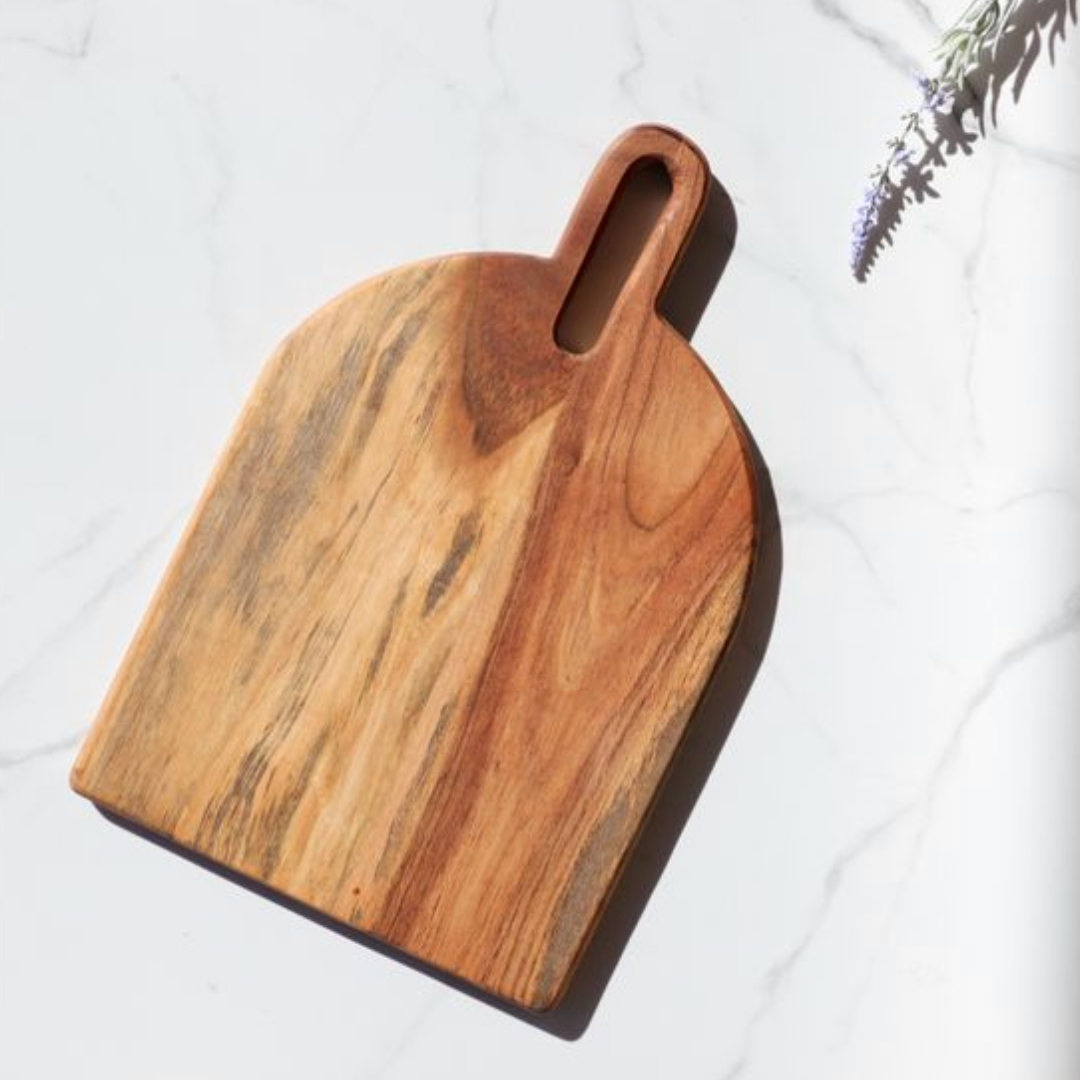 A brown wooden serving board with a handle.