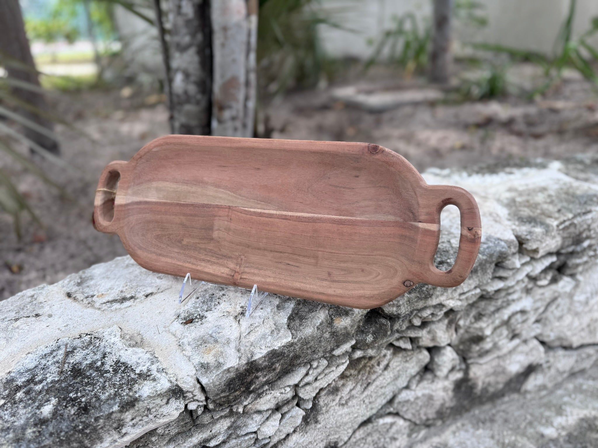 A wooden serving board with handles.